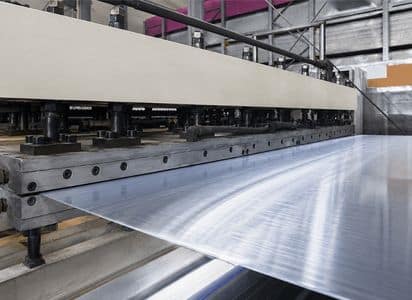 Extruded PVC sheet being formed through a die at Adams Plastics